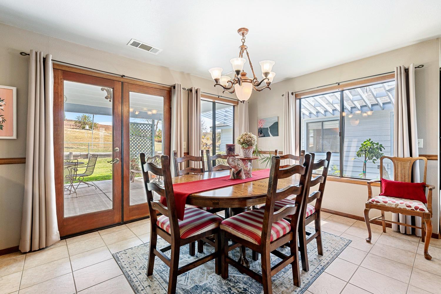 36360 Highway 33 Coalinga, CA 93210 - Photo 31 of 50 a view of a dining room with furniture large windows and wooden floor