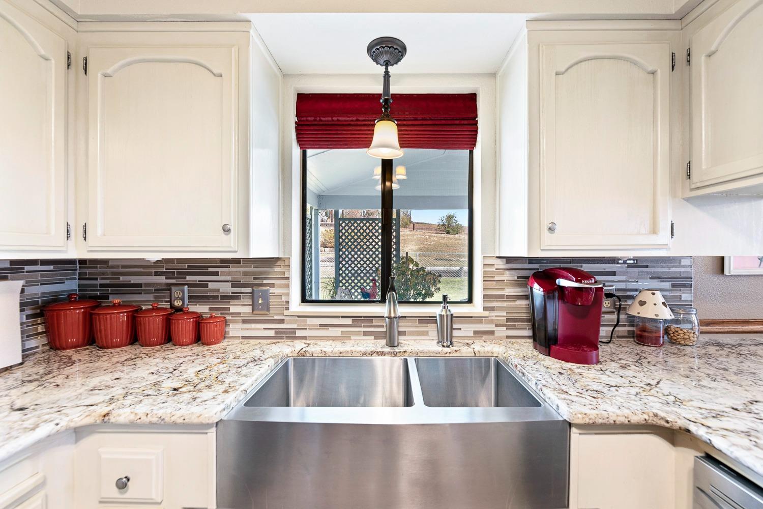 36360 Highway 33 Coalinga, CA 93210 - Photo 32 of 50 a kitchen with granite countertop a sink and a counter top space