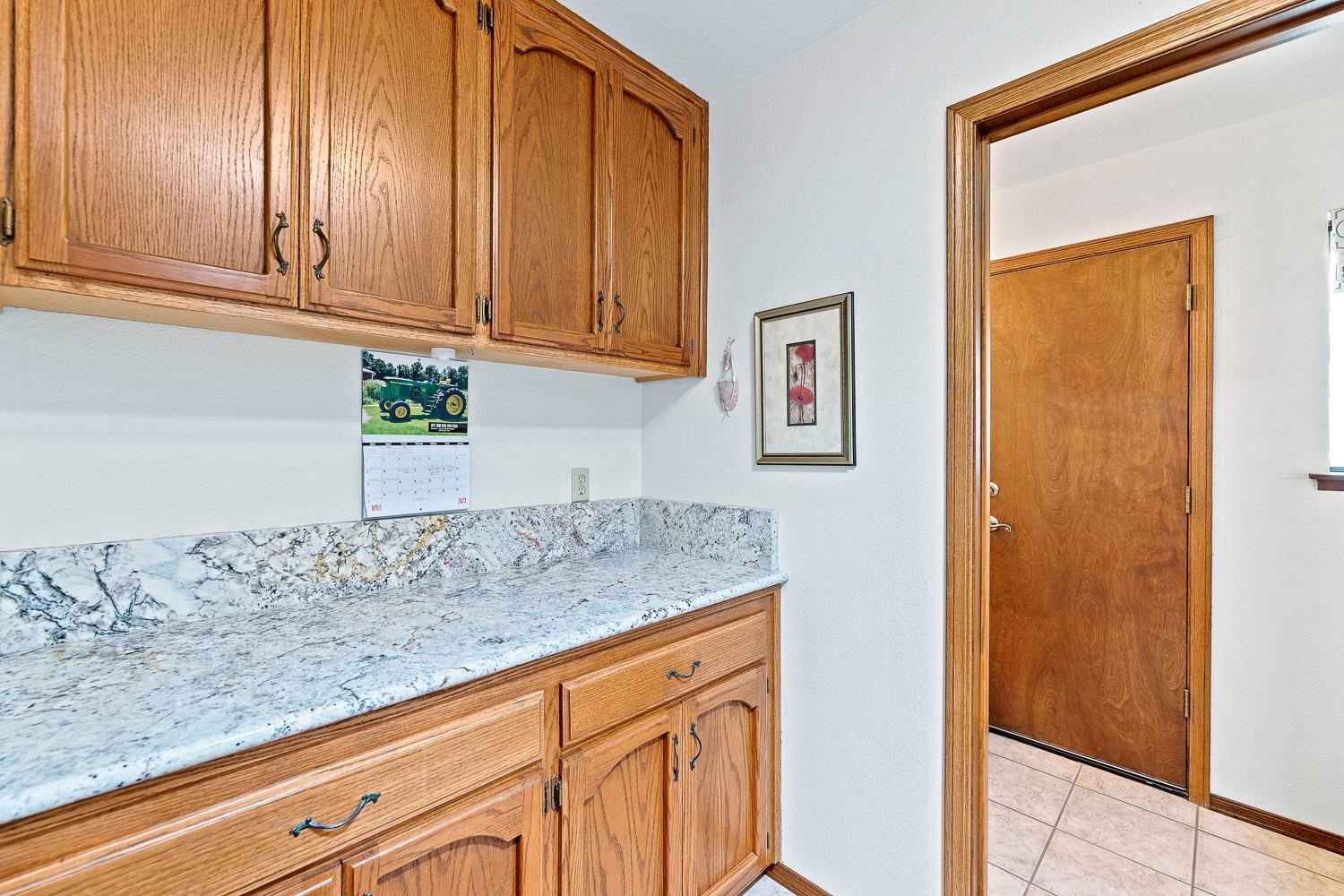 36360 Highway 33 Coalinga, CA 93210 - Photo 38 of 50 a kitchen with granite countertop cabinets and black appliances