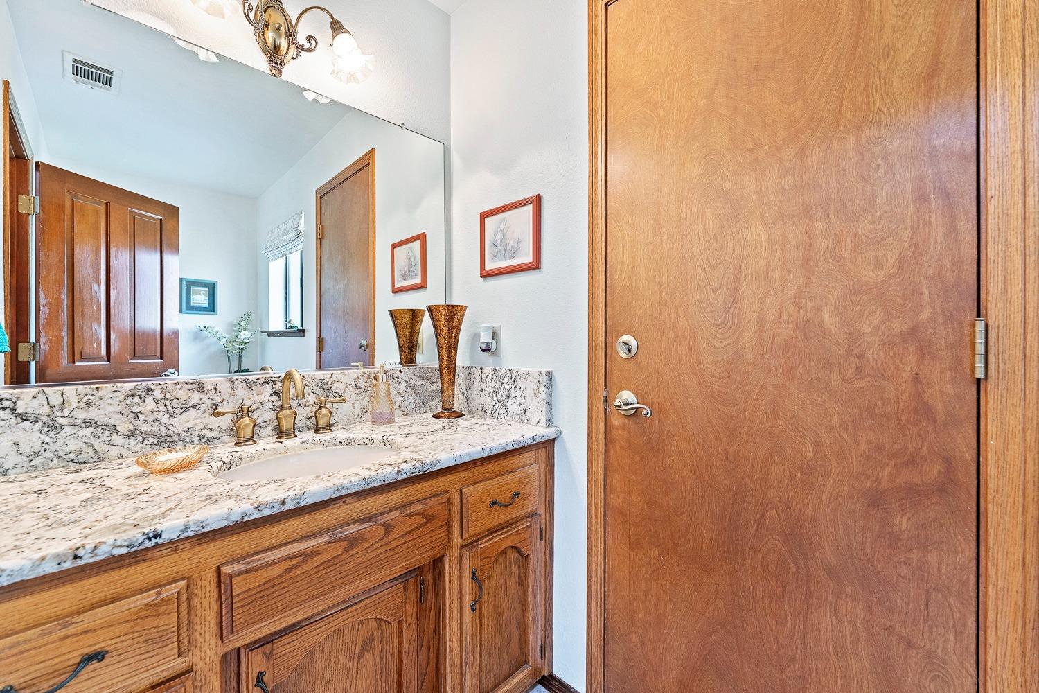 36360 Highway 33 Coalinga, CA 93210 - Photo 39 of 50 a bathroom with a granite countertop sink and a mirror
