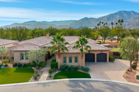 a view of a house with a garden and a mountain view