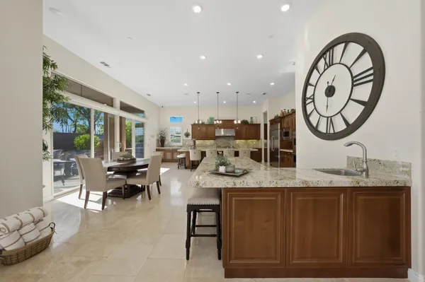 a kitchen with a stove a sink a refrigerator and a oven