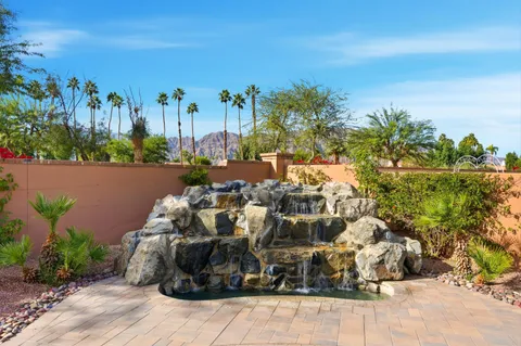 a living room with granite countertop furniture a clock and a view of living room
