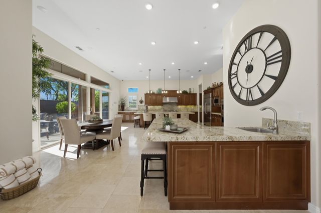 a view of a dining area with furniture and a clock