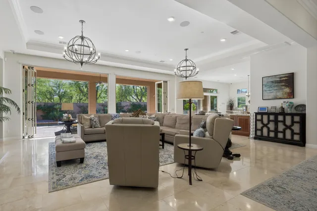 a spacious bedroom with a bed and a flat screen tv