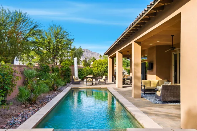 a view of a patio with table and chairs with wooden floor and fence