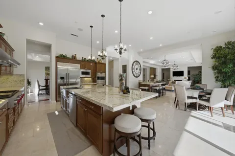 a living room with furniture and a ceiling fan