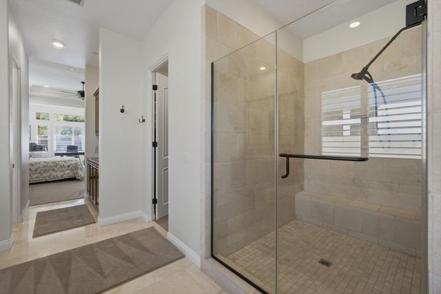 a bedroom with a bed furniture and a large window