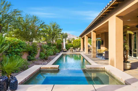 a outdoor space with the couches and dining table with the garden view