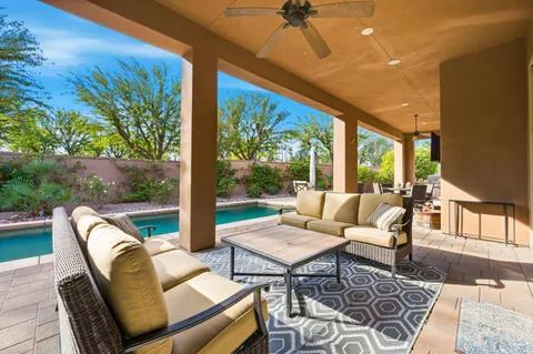 a view of a house with backyard porch and sitting area