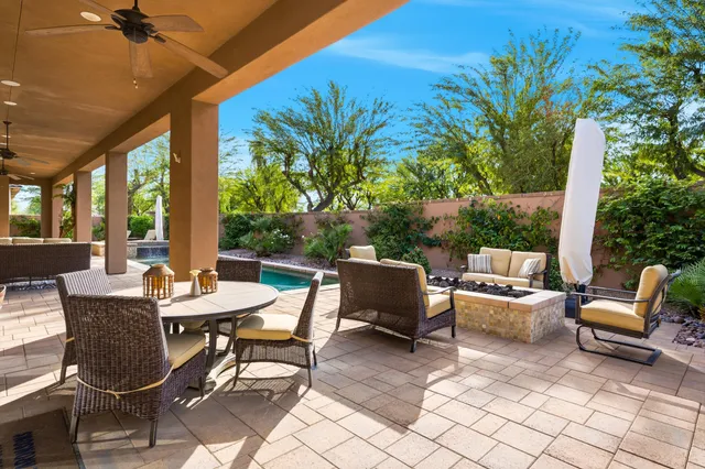 a backyard of a house with outdoor seating