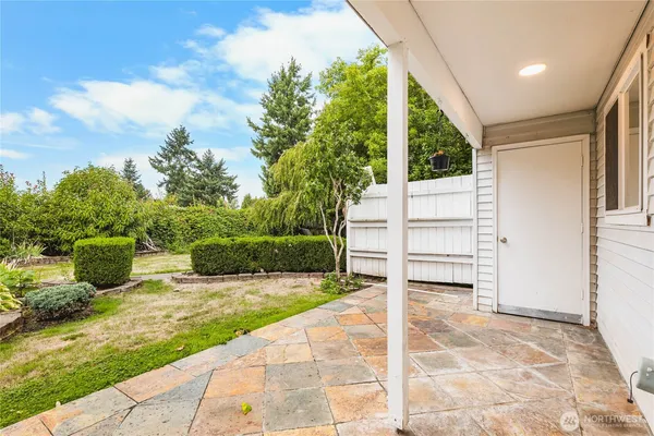 a view of house with backyard and sitting area