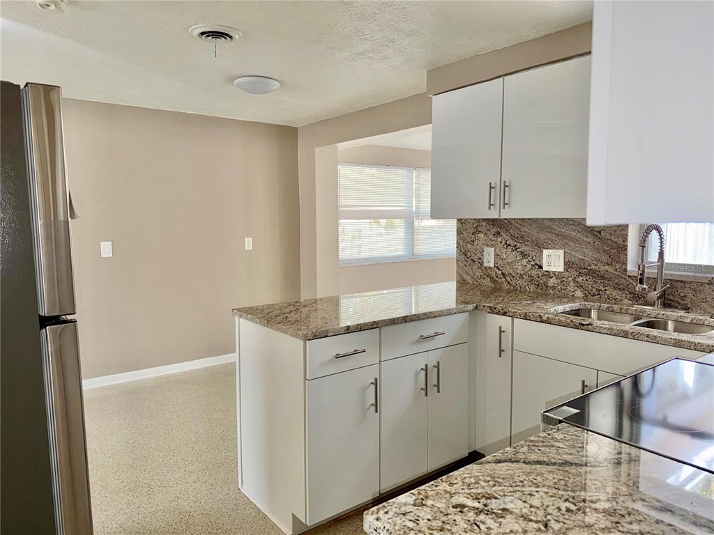 7441 Banner Street New Port Richey, FL 34653 - Photo 11 of 20 a kitchen with a sink cabinets and window