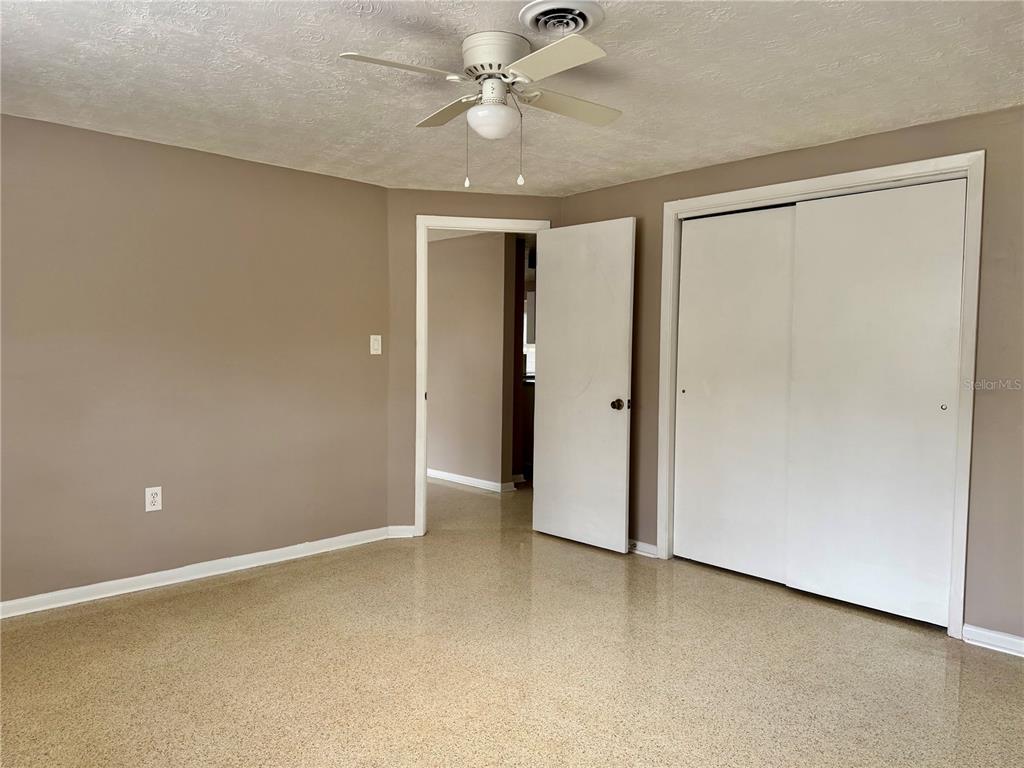 7441 Banner Street New Port Richey, FL 34653 - Photo 13 of 20 an empty room with closet and a ceiling fan