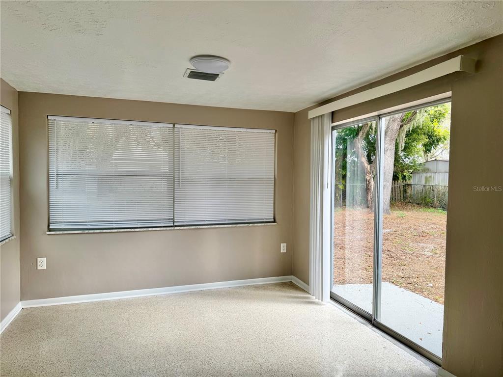 7441 Banner Street New Port Richey, FL 34653 - Photo 17 of 20 an empty room with sliding glass door