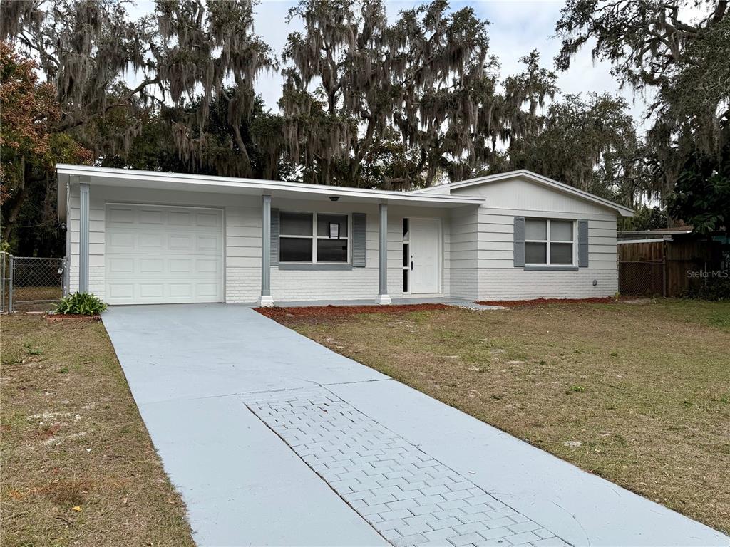7441 Banner Street New Port Richey, FL 34653 - Photo 6 of 20 a front view of house with yard and trees in the background