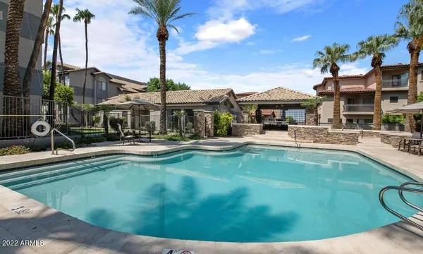 a swimming pool with outdoor seating yard and barbeque oven