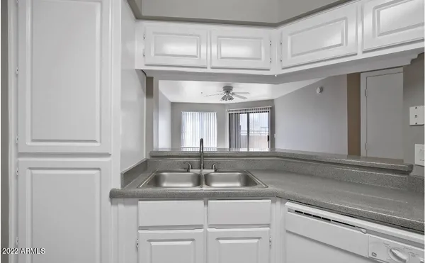 a sink with white cabinets
