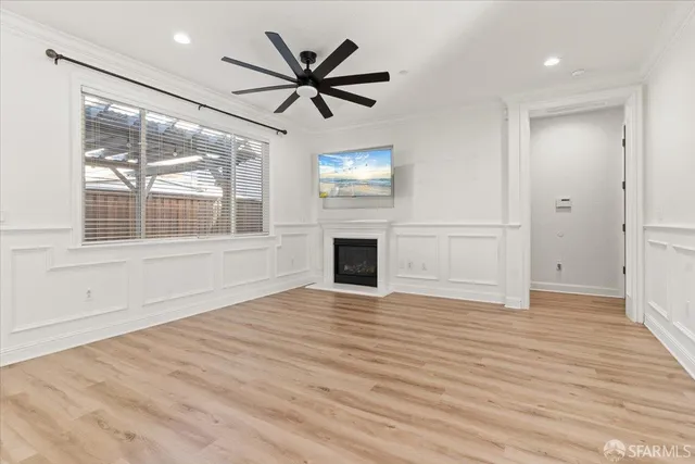 a view of empty room with wooden floor and windows