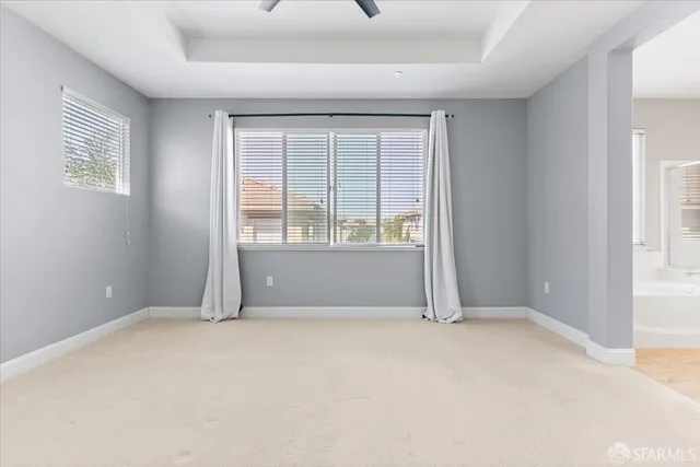 a spacious bathroom with a toilet sink and mirror