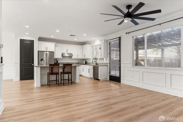a kitchen with stainless steel appliances kitchen island wooden cabinets and granite counter top