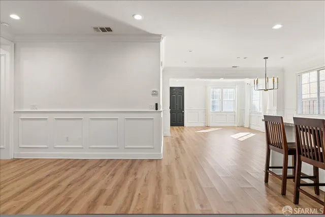 a kitchen with stainless steel appliances granite countertop a table chairs sink refrigerator and cabinets