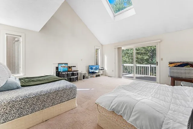 a bedroom with a bed couch and a window