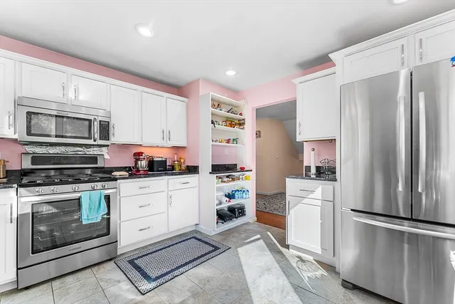 a kitchen with stainless steel appliances a refrigerator sink and microwave