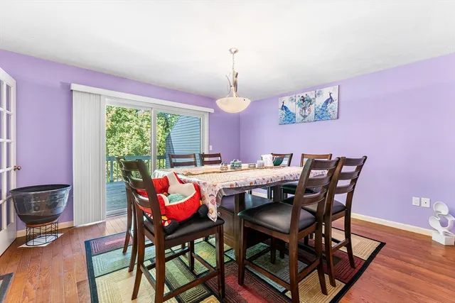 a dining room with furniture a chandelier and wooden floor