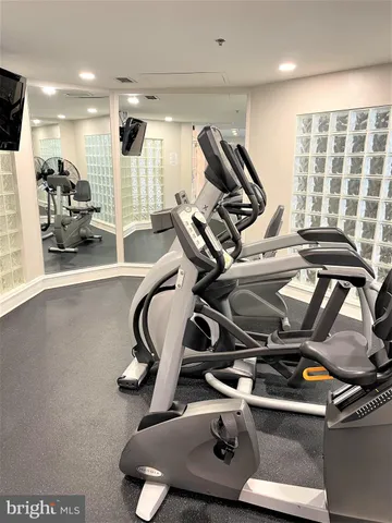 a view of a room with gym equipment and a large window