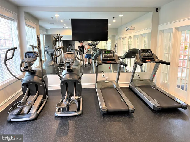 a room with furniture pool table and windows