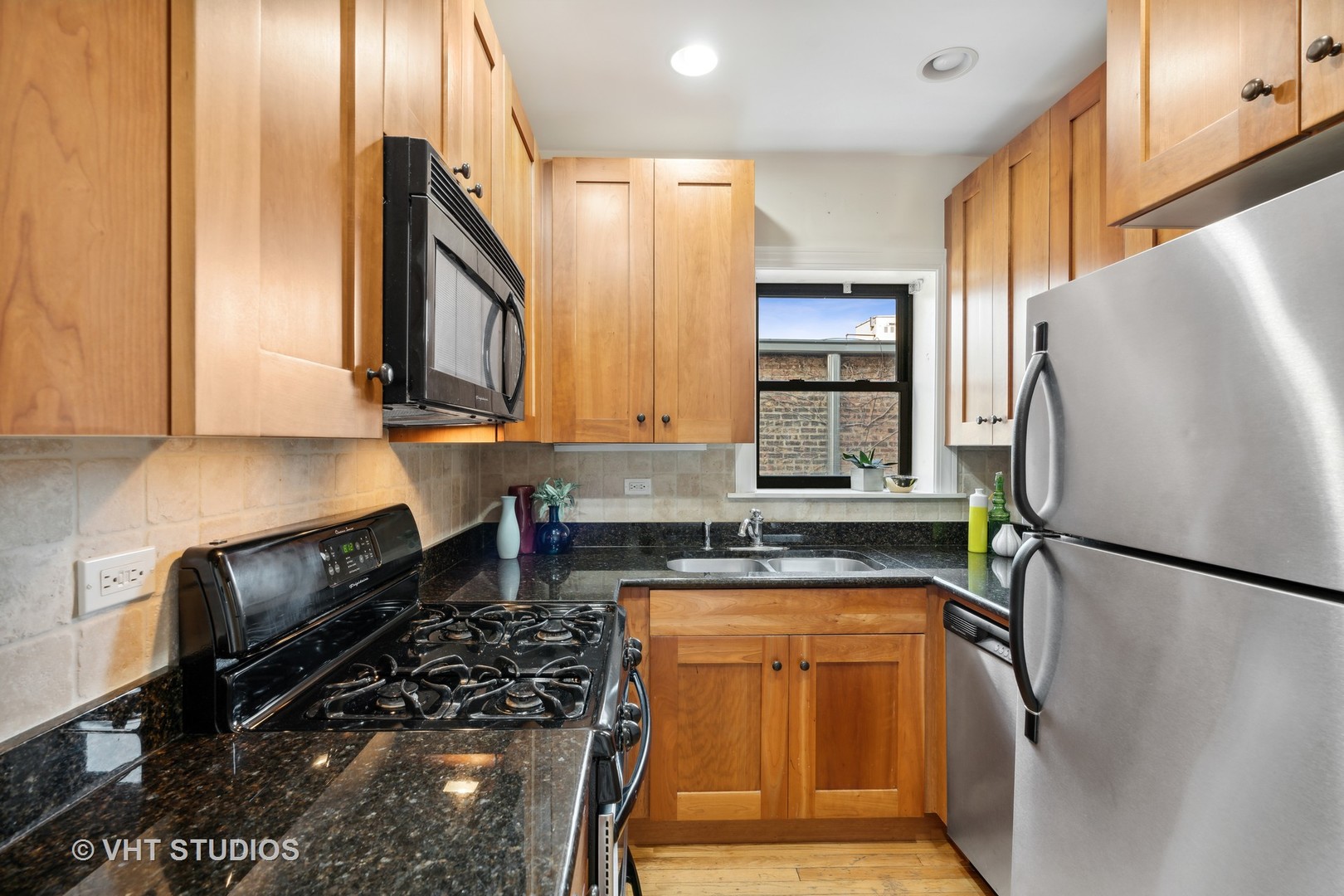 1155 West Grace Street, Unit 2N Chicago, IL 60613 - Photo 11 of 20 a kitchen with a refrigerator a stove a sink and cabinets