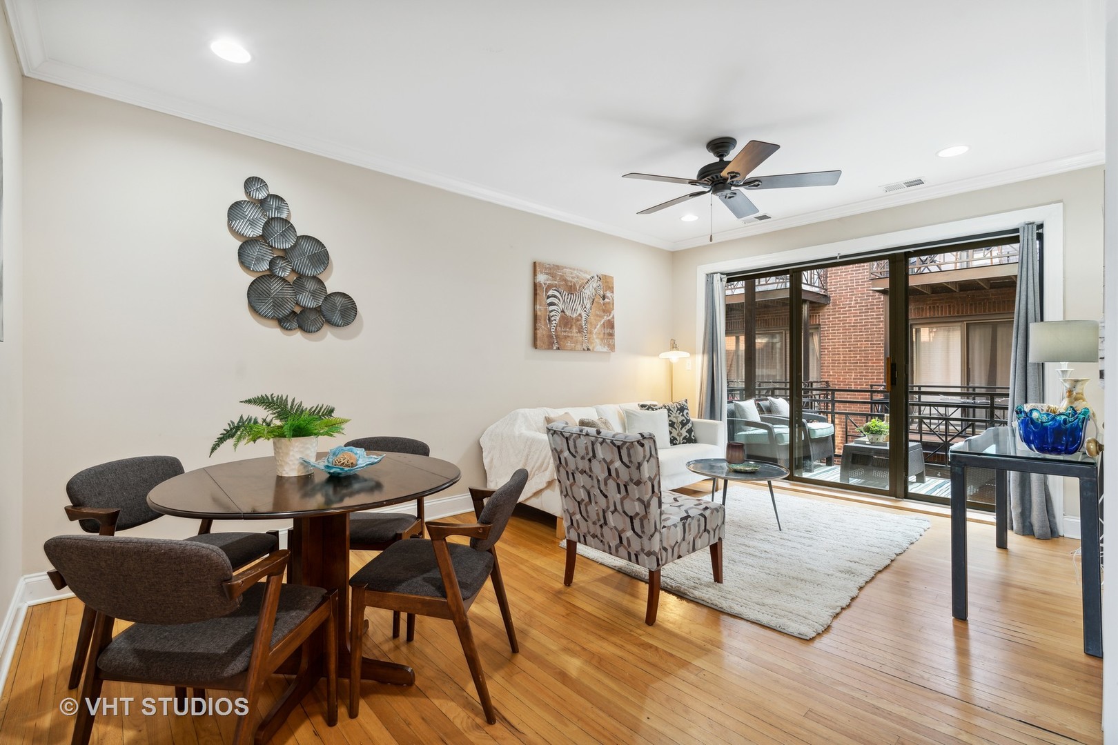 1155 West Grace Street, Unit 2N Chicago, IL 60613 - Photo 3 of 20 a dining room with furniture a chandelier and wooden floor