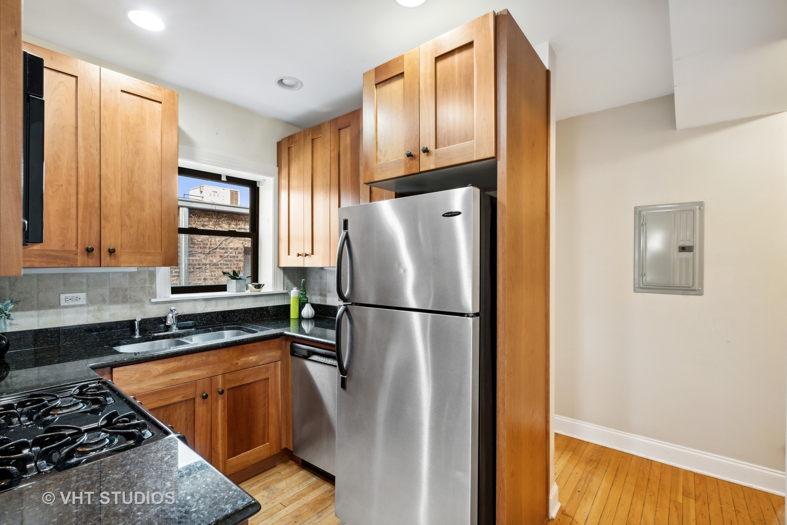 1155 West Grace Street, Unit 2N Chicago, IL 60613 - Photo 9 of 20 a kitchen with refrigerator a stove a sink and a window