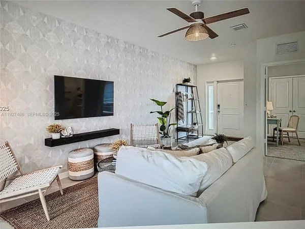 a living room with furniture and a flat screen tv