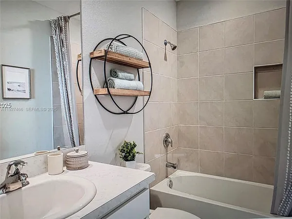 a bathroom with a sink toilet and a mirror
