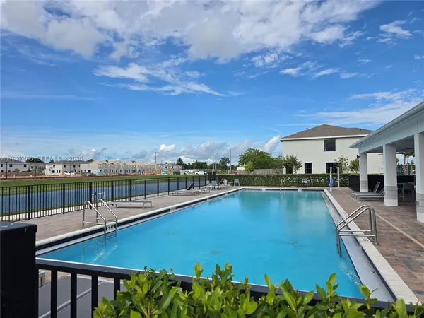a view of a swimming pool and lounge chair