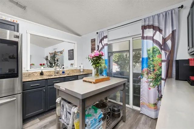 a kitchen with a refrigerator and a table