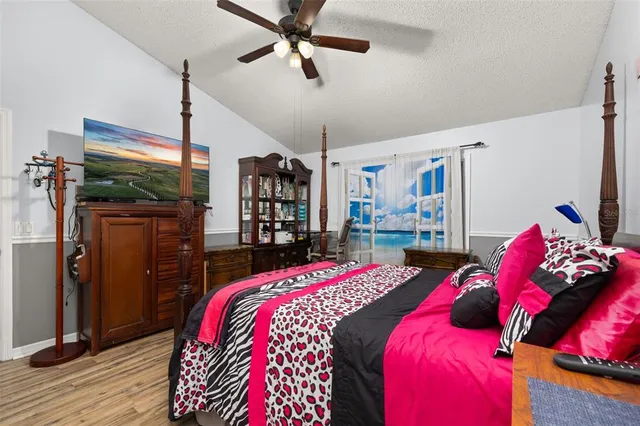 a bedroom with a bed with wooden floor