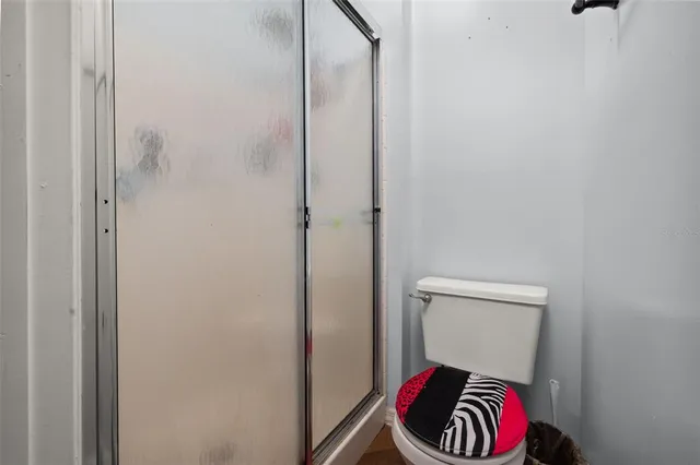 a bathroom with a toilet and a shower