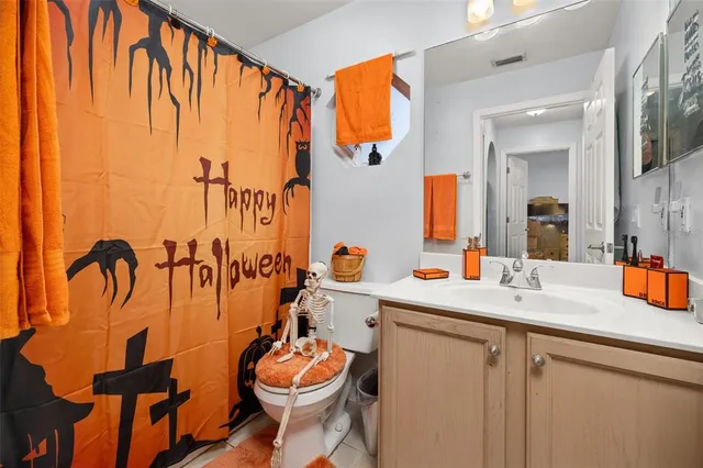 a bathroom with a sink mirror and toilet