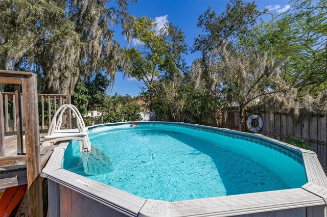 a view of a swimming pool with a yard