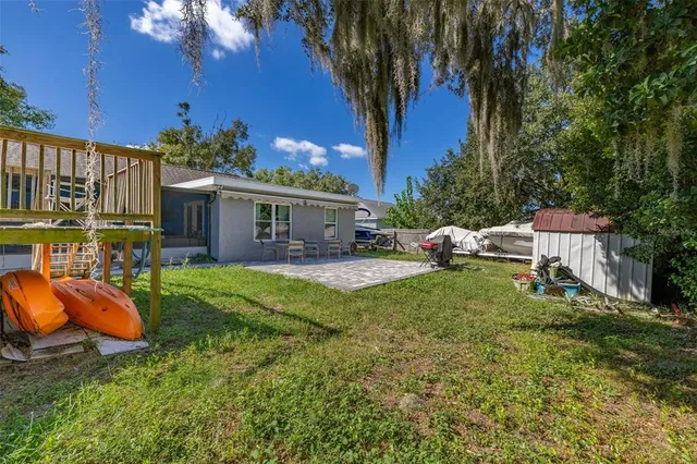 a view of a house with backyard porch and sitting area