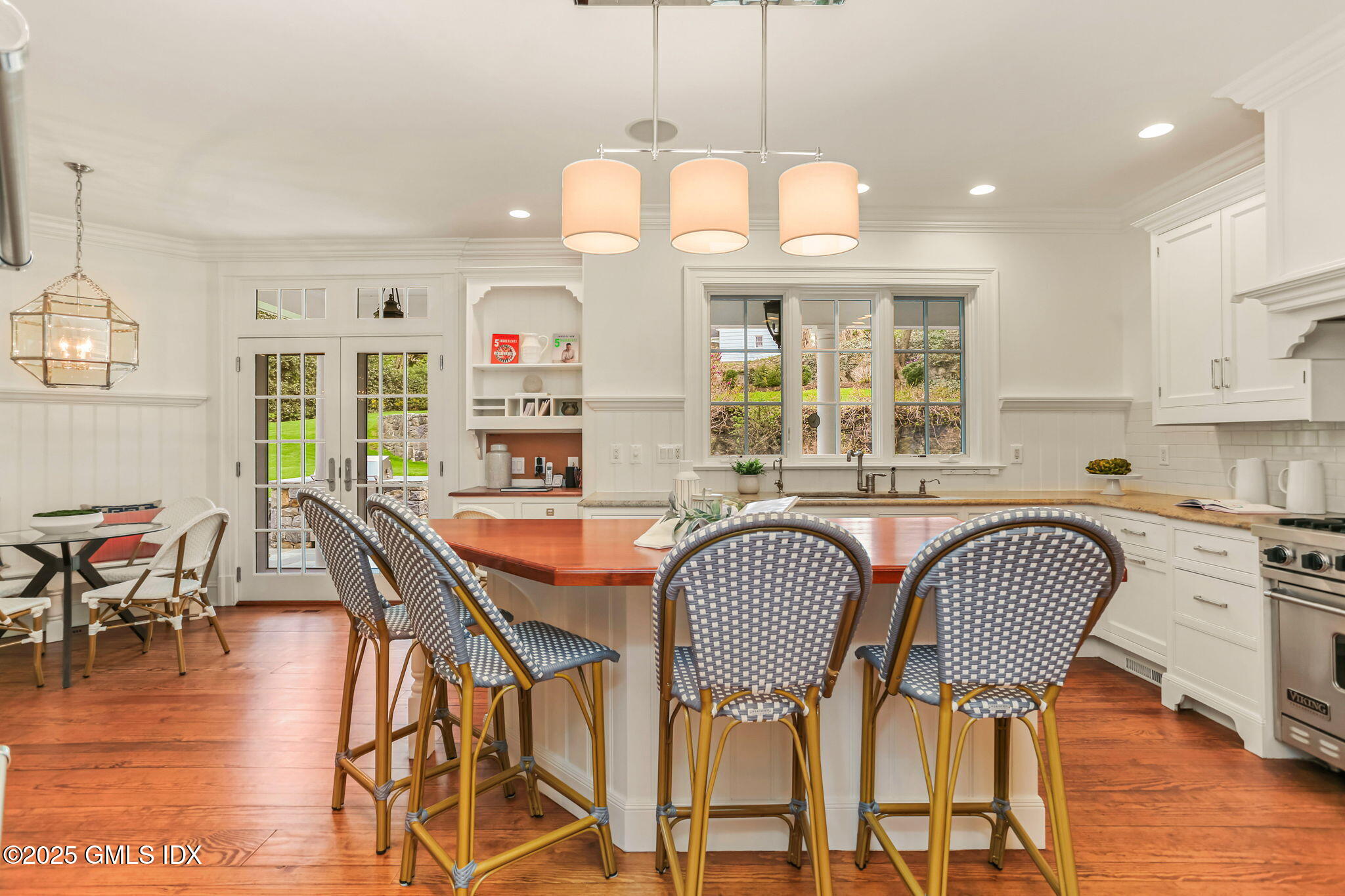 10 Francine Drive Greenwich, CT 06830 - Photo 20 of 59 a dining room with furniture a chandelier and wooden floor