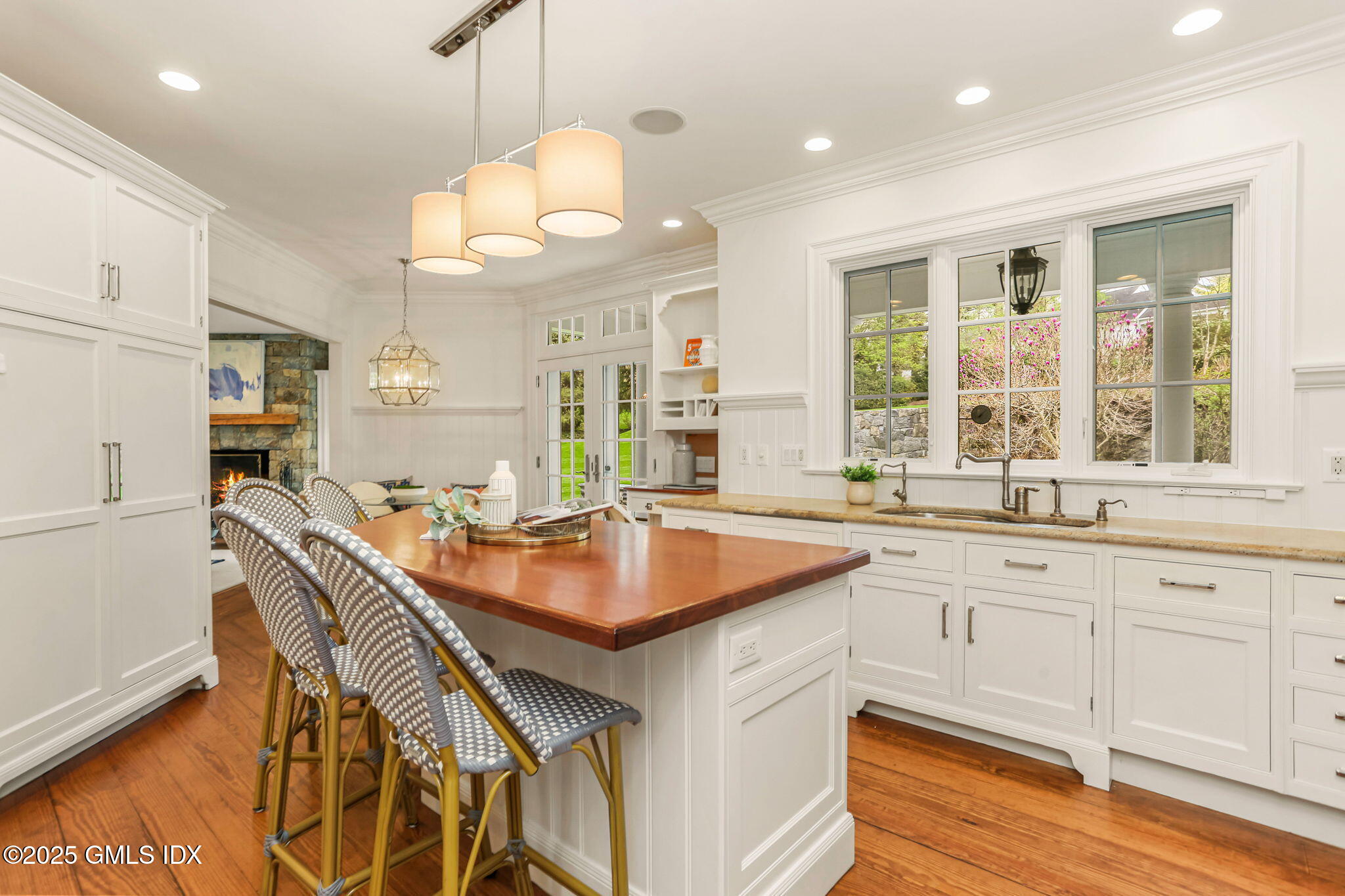 10 Francine Drive Greenwich, CT 06830 - Photo 21 of 59 a kitchen with granite countertop a sink a center island and cabinets