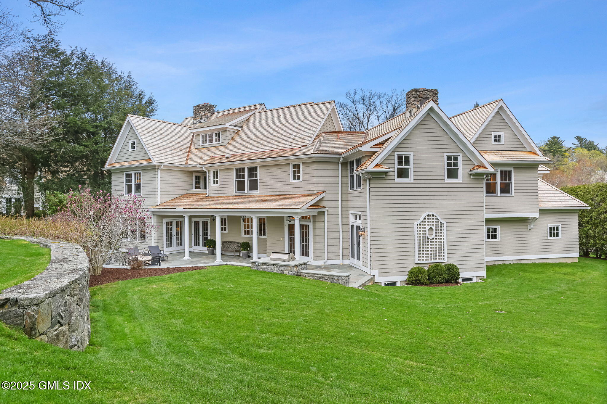 10 Francine Drive Greenwich, CT 06830 - Photo 4 of 59 a front view of a house with a garden and trees