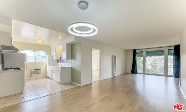 a view of a kitchen with a sink and a refrigerator