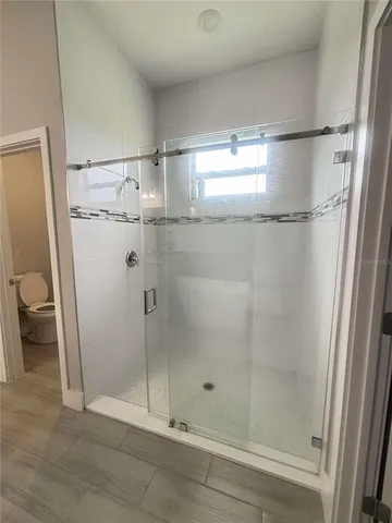 a bathroom with a glass door shower