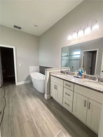 a spacious bathroom with a double vanity sink and a mirror