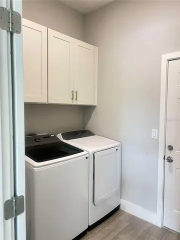 a view of cabinets and utility room with washer and dryer